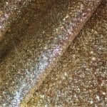 232-3 Gold avetco.leather1245 | Avetco Leather Hides and Eva Foam The Chunky Glitter fabric collection is ideal for adding a touch of sparkle to your projects such as shoes, handbags, hats, bows, garments, belts, and accessories. The material is made of Glitter Fabric PET in round and hexagon shapes with a polyester twill fabric backing. It has a width of 54 inches with a tolerance of ± 0.5" and a thickness of 1.3mm (0.05"). The country of origin is China.