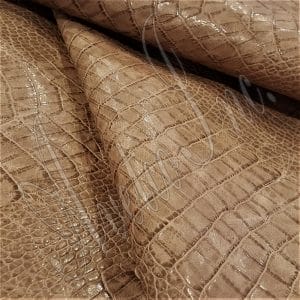 The Alligator leather is a highly attractive and unique type of leather that boasts an exotic style and color tone that is truly mesmerizing. It is a corrected grain leather that is sourced from Europe and has been specially embossed to reproduce the pattern of alligator skin, which gives it a very prominent appearance. The leather's deep texture and rich tone variation are completed by a stucco-finish on the surface, which gives it a smooth surface with a subtle shine.