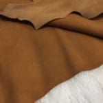 goat suede leather almond avetcoinc@ | Avetco Leather Hides and Eva Foam The Goatskin Suede Leather features a wonderful texture that is eye-catching and feels luxurious to the touch. Its versatility stems from a distinctive tanning method that involves gentle buffing, making it ideal for use in various items such as clothing, moccasins, lining, handbags, shoes, and accessories. Those who value timeless elegance and quality will undoubtedly find this leather worth the investment, as it guarantees utmost quality and worth through full hide pieces that typically range in size between 2-4 square feet and have a thickness of 3 oz (1.0-1.1mm). What is Goat Suede? Goat suede undergoes an extra finishing process that creates a velvety texture. This process involves buffing the flesh side of the hide, resulting in a soft and textured nap that feels wonderful to the touch.