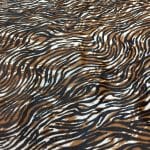 Cowhide with striking black and brown zebra print. Ideal for handbags, shoes, garments, upholstery, pillows, and décor. Natural, bold, and stylish finish.