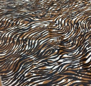 Cowhide with striking black and brown zebra print. Ideal for handbags, shoes, garments, upholstery, pillows, and décor. Natural, bold, and stylish finish.