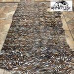 Cowhide with striking black and brown zebra print. Ideal for handbags, shoes, garments, upholstery, pillows, and décor. Natural, bold, and stylish finish.