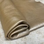 The Hudson Metallic Collection - a unique style that boasts a distressed look and pearlized finish. The leather has a smooth and silky surface, showcasing an array of vibrant colors that shimmer in the light. This collection features natural drum-dyed leather that is full grain and made from full-hide cowhide. With an average hide size of 18-20 square feet, the leather is 3 ounces thick (1.0 - 1.2mm) with a pearlized natural grain texture. The temper is medium-soft, and the tannage is chrome-tanned.