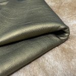 The Hudson Metallic Collection - a unique style that boasts a distressed look and pearlized finish. The leather has a smooth and silky surface, showcasing an array of vibrant colors that shimmer in the light. This collection features natural drum-dyed leather that is full grain and made from full-hide cowhide. With an average hide size of 18-20 square feet, the leather is 3 ounces thick (1.0 - 1.2mm) with a pearlized natural grain texture. The temper is medium-soft, and the tannage is chrome-tanned.