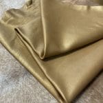 The Hudson Metallic Collection - a unique style that boasts a distressed look and pearlized finish. The leather has a smooth and silky surface, showcasing an array of vibrant colors that shimmer in the light. This collection features natural drum-dyed leather that is full grain and made from full-hide cowhide. With an average hide size of 18-20 square feet, the leather is 3 ounces thick (1.0 - 1.2mm) with a pearlized natural grain texture. The temper is medium-soft, and the tannage is chrome-tanned.