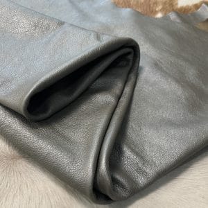 The Hudson Metallic Collection - a unique style that boasts a distressed look and pearlized finish. The leather has a smooth and silky surface, showcasing an array of vibrant colors that shimmer in the light. This collection features natural drum-dyed leather that is full grain and made from full-hide cowhide. With an average hide size of 18-20 square feet, the leather is 3 ounces thick (1.0 - 1.2mm) with a pearlized natural grain texture. The temper is medium-soft, and the tannage is chrome-tanned.