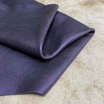 The Hudson Metallic Collection - a unique style that boasts a distressed look and pearlized finish. The leather has a smooth and silky surface, showcasing an array of vibrant colors that shimmer in the light. This collection features natural drum-dyed leather that is full grain and made from full-hide cowhide. With an average hide size of 18-20 square feet, the leather is 3 ounces thick (1.0 - 1.2mm) with a pearlized natural grain texture. The temper is medium-soft, and the tannage is chrome-tanned.