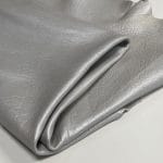 The Hudson Metallic Collection - a unique style that boasts a distressed look and pearlized finish. The leather has a smooth and silky surface, showcasing an array of vibrant colors that shimmer in the light. This collection features natural drum-dyed leather that is full grain and made from full-hide cowhide. With an average hide size of 18-20 square feet, the leather is 3 ounces thick (1.0 - 1.2mm) with a pearlized natural grain texture. The temper is medium-soft, and the tannage is chrome-tanned.