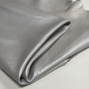 The Hudson Metallic Collection - a unique style that boasts a distressed look and pearlized finish. The leather has a smooth and silky surface, showcasing an array of vibrant colors that shimmer in the light. This collection features natural drum-dyed leather that is full grain and made from full-hide cowhide. With an average hide size of 18-20 square feet, the leather is 3 ounces thick (1.0 - 1.2mm) with a pearlized natural grain texture. The temper is medium-soft, and the tannage is chrome-tanned.