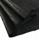 Black4 | Avetco Leather Hides and Eva Foam Ostrich Embossed Cow Leather is made of European leather with a unique embossed grain texture that resembles Ostrich skin. Its rough appearance, complete with grooves and bumps, makes it beautiful and durable. The leather has a waxed finish that adds smoothness and shine to its surface. This collection uses chrome tanning, which gives it a luxurious and rich look.