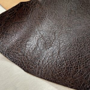 Crafted from premium cowhide, this double shoulder leather features an intricate elephant embossing pattern that adds a bold, exotic texture to any project