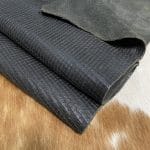 Introducing Alexa Veg Tanned Cow Leather - a special type of leather that is crafted from full grain hide and treated with vegetal tanning. This unique leather boasts a reptile scale-like appearance, but with a more polished and refined look. An aniline finish gives it a waxy, matte texture, while deep grooves outline each square, highlighting their appearance. The squares are also creased, adding texture and definition. The Alexa collection is perfect for various leather needs due to its subtle shine and remarkable design. This leather is made from heifer (double shoulder) and weighs 5/6 oz. (2.2 mm-2.4 mm). It is 100% veg-tanned and dyed through (drum dye). The leather is classified as full-grain with a medium pull-up, has a semi-soft temper, and is sourced from Mexico. The Alexa leather is perfect for crafting straps, handbags, accessories, footwear, belts, and leather crafts.