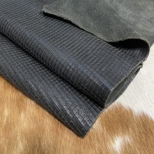 Introducing Alexa Veg Tanned Cow Leather - a special type of leather that is crafted from full grain hide and treated with vegetal tanning. This unique leather boasts a reptile scale-like appearance, but with a more polished and refined look. An aniline finish gives it a waxy, matte texture, while deep grooves outline each square, highlighting their appearance. The squares are also creased, adding texture and definition. The Alexa collection is perfect for various leather needs due to its subtle shine and remarkable design. This leather is made from heifer (double shoulder) and weighs 5/6 oz. (2.2 mm-2.4 mm). It is 100% veg-tanned and dyed through (drum dye). The leather is classified as full-grain with a medium pull-up, has a semi-soft temper, and is sourced from Mexico. The Alexa leather is perfect for crafting straps, handbags, accessories, footwear, belts, and leather crafts.