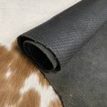 Introducing Alexa Veg Tanned Cow Leather - a special type of leather that is crafted from full grain hide and treated with vegetal tanning. This unique leather boasts a reptile scale-like appearance, but with a more polished and refined look. An aniline finish gives it a waxy, matte texture, while deep grooves outline each square, highlighting their appearance. The squares are also creased, adding texture and definition. The Alexa collection is perfect for various leather needs due to its subtle shine and remarkable design. This leather is made from heifer (double shoulder) and weighs 5/6 oz. (2.2 mm-2.4 mm). It is 100% veg-tanned and dyed through (drum dye). The leather is classified as full-grain with a medium pull-up, has a semi-soft temper, and is sourced from Mexico. The Alexa leather is perfect for crafting straps, handbags, accessories, footwear, belts, and leather crafts.