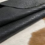 Introducing Alexa Veg Tanned Cow Leather - a special type of leather that is crafted from full grain hide and treated with vegetal tanning. This unique leather boasts a reptile scale-like appearance, but with a more polished and refined look. An aniline finish gives it a waxy, matte texture, while deep grooves outline each square, highlighting their appearance. The squares are also creased, adding texture and definition. The Alexa collection is perfect for various leather needs due to its subtle shine and remarkable design. This leather is made from heifer (double shoulder) and weighs 5/6 oz. (2.2 mm-2.4 mm). It is 100% veg-tanned and dyed through (drum dye). The leather is classified as full-grain with a medium pull-up, has a semi-soft temper, and is sourced from Mexico. The Alexa leather is perfect for crafting straps, handbags, accessories, footwear, belts, and leather crafts.