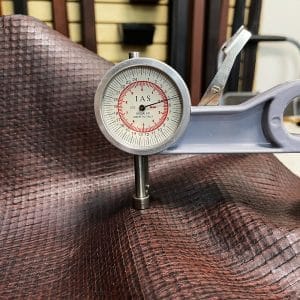 Introducing Alexa Veg Tanned Cow Leather - a special type of leather that is crafted from full grain hide and treated with vegetal tanning. This unique leather boasts a reptile scale-like appearance, but with a more polished and refined look. An aniline finish gives it a waxy, matte texture, while deep grooves outline each square, highlighting their appearance. The squares are also creased, adding texture and definition. The Alexa collection is perfect for various leather needs due to its subtle shine and remarkable design. This leather is made from heifer (double shoulder) and weighs 5/6 oz. (2.2 mm-2.4 mm). It is 100% veg-tanned and dyed through (drum dye). The leather is classified as full-grain with a medium pull-up, has a semi-soft temper, and is sourced from Mexico. The Alexa leather is perfect for crafting straps, handbags, accessories, footwear, belts, and leather crafts.