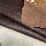 Introducing Alexa Veg Tanned Cow Leather - a special type of leather that is crafted from full grain hide and treated with vegetal tanning. This unique leather boasts a reptile scale-like appearance, but with a more polished and refined look. An aniline finish gives it a waxy, matte texture, while deep grooves outline each square, highlighting their appearance. The squares are also creased, adding texture and definition. The Alexa collection is perfect for various leather needs due to its subtle shine and remarkable design. This leather is made from heifer (double shoulder) and weighs 5/6 oz. (2.2 mm-2.4 mm). It is 100% veg-tanned and dyed through (drum dye). The leather is classified as full-grain with a medium pull-up, has a semi-soft temper, and is sourced from Mexico. The Alexa leather is perfect for crafting straps, handbags, accessories, footwear, belts, and leather crafts.