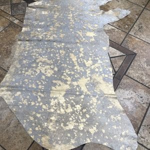 This stunning hair-on cowhide features a luxurious metallic gold overlay on a natural white base, creating a perfect balance of glam and organic beauty. Ideal for handbags, upholstery, wall art, footwear, and fashion accessories.