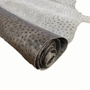 Ostrich Embossed Cow Leather is made of European leather with a unique embossed grain texture that resembles Ostrich skin. Its rough appearance, complete with grooves and bumps, makes it beautiful and durable. The leather has a waxed finish that adds smoothness and shine to its surface. This collection uses chrome tanning, which gives it a luxurious and rich look.