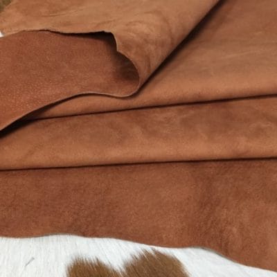 What is nubuck leather This material is suitable for footwear, accessories, handbags, apparel, craft, belts, and DIY projects. Nubuck leather is swine (pig leather) that has a medium soft temper and a chrome tannage. It has a texture that is referred to as nubuck and an average hide size of 8-10 sq. ft. The thickness is 3 oz. (1.0 – 1.2 mm). The raw material comes from the subspecies Sus scrofa domesticus and is from Taiwan. It can be used for DIY projects.