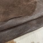 The Jelly Satin Suede Collection features high-quality leather products made from European cowhide treated with a glittery surface. The leather has a smooth suede texture in one direction and a coarser texture in the other, perfect for creating unique textures. Its shimmery yet subtle exterior creates a modern and chic look, ideal for footwear, garments, accessories, and more. The collection is made in Turkey using chrome tanning, which requires fewer chemicals and produces a more consistent color. It's free of harmful chemicals like PCP, Azo Pigments, Chrome VI, Formaldehyde, and APEO. This collection is perfect for those who value quality, style, and durability.