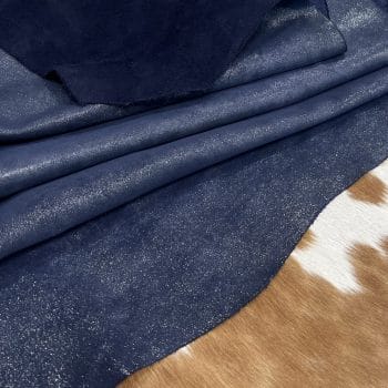 The Jelly Satin Suede Collection features high-quality leather products made from European cowhide treated with a glittery surface. The leather has a smooth suede texture in one direction and a coarser texture in the other, perfect for creating unique textures. Its shimmery yet subtle exterior creates a modern and chic look, ideal for footwear, garments, accessories, and more. The collection is made in Turkey using chrome tanning, which requires fewer chemicals and produces a more consistent color. It's free of harmful chemicals like PCP, Azo Pigments, Chrome VI, Formaldehyde, and APEO. This collection is perfect for those who value quality, style, and durability.