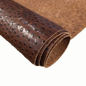Ostrich Embossed Cow Leather is made of European leather with a unique embossed grain texture that resembles Ostrich skin. Its rough appearance, complete with grooves and bumps, makes it beautiful and durable. The leather has a waxed finish that adds smoothness and shine to its surface. This collection uses chrome tanning, which gives it a luxurious and rich look.