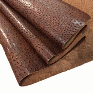 Ostrich Embossed Cow Leather is made of European leather with a unique embossed grain texture that resembles Ostrich skin. Its rough appearance, complete with grooves and bumps, makes it beautiful and durable. The leather has a waxed finish that adds smoothness and shine to its surface. This collection uses chrome tanning, which gives it a luxurious and rich look.
