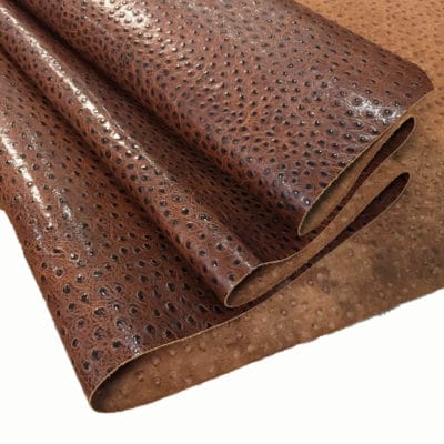 Ostrich Embossed Cow Leather is made of European leather with a unique embossed grain texture that resembles Ostrich skin. Its rough appearance, complete with grooves and bumps, makes it beautiful and durable. The leather has a waxed finish that adds smoothness and shine to its surface. This collection uses chrome tanning, which gives it a luxurious and rich look.