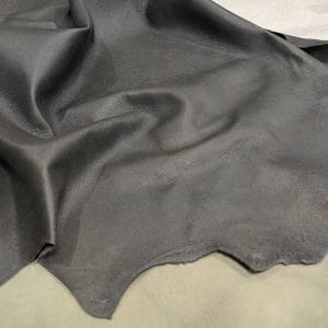 The Lambskin Crackle" is a collection of finely crafted pieces made from the finest lambskin leather. Each piece is designed to showcase unparalleled softness and elegance. The meticulous tanning process involves delicately applying wax to the surface, which creates a captivating crackle effect. This adds depth and character to the leather. The matte finish and rich olive night color further enhance its allure, providing a visually and tactilely stunning experience. The collection offers a versatile range of possibilities for those who appreciate the finer things in life. It's perfect for elevating your wardrobe with statement apparel, accessorizing with chic handbags, stepping out in style with sophisticated shoes, or indulging in artisanal leather crafting.