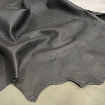 The Lambskin Crackle" is a collection of finely crafted pieces made from the finest lambskin leather. Each piece is designed to showcase unparalleled softness and elegance. The meticulous tanning process involves delicately applying wax to the surface, which creates a captivating crackle effect. This adds depth and character to the leather. The matte finish and rich olive night color further enhance its allure, providing a visually and tactilely stunning experience. The collection offers a versatile range of possibilities for those who appreciate the finer things in life. It's perfect for elevating your wardrobe with statement apparel, accessorizing with chic handbags, stepping out in style with sophisticated shoes, or indulging in artisanal leather crafting.