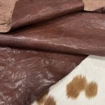 The Goatskin-washed Leather Collection offers an exclusive range of leather that undergoes a special tanning process, resulting in a unique and irregular texture. The leather's shrunken grain creates a striking and dynamic appearance, while its distressed look adds to its appeal. The thickness of the leather adds to its durability and dependability. The collection features a variety of warm and distinct colors that make it ideal for creating timeless looks.
