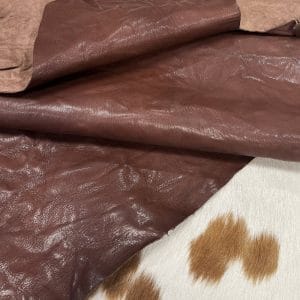 The Goatskin-washed Leather Collection offers an exclusive range of leather that undergoes a special tanning process, resulting in a unique and irregular texture. The leather's shrunken grain creates a striking and dynamic appearance, while its distressed look adds to its appeal. The thickness of the leather adds to its durability and dependability. The collection features a variety of warm and distinct colors that make it ideal for creating timeless looks.