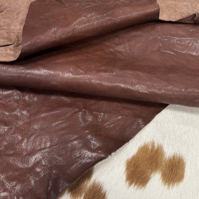 The Goatskin-washed Leather Collection offers an exclusive range of leather that undergoes a special tanning process, resulting in a unique and irregular texture. The leather's shrunken grain creates a striking and dynamic appearance, while its distressed look adds to its appeal. The thickness of the leather adds to its durability and dependability. The collection features a variety of warm and distinct colors that make it ideal for creating timeless looks.