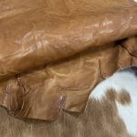 The Goatskin-washed Leather Collection offers an exclusive range of leather that undergoes a special tanning process, resulting in a unique and irregular texture. The leather's shrunken grain creates a striking and dynamic appearance, while its distressed look adds to its appeal. The thickness of the leather adds to its durability and dependability. The collection features a variety of warm and distinct colors that make it ideal for creating timeless looks.