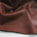 The Stretch Nappa Lambskin Collection! This European full-grain leather features integrated stretchable fibers for increased elasticity, making it perfect for garments, gloves, skirts, jackets, footwear, and accessories. Available in twelve vibrant colors, this durable and smooth leather undergoes a drum-dye process to enhance pigmentation. Originating from Turkey, it is 0.5 – 0.7 mm thick and made from lambskin (Nappa) with a base fabric of 97-98% cotton and 3-2% Lycra.