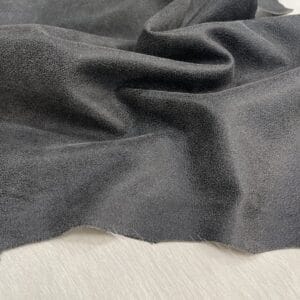 Black crackle leather with subtle pebble texture and off-white base, shown flat to highlight topcoat finish.