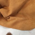 What is pig Leather Pig Leather collection - a range of leather products crafted from split suede material with a velvety texture. This leather is not only incredibly soft but also comes in a stunning array of colors that are sure to please any fashion enthusiast. The collection's versatile hues are perfect for creating a variety of atmospheres, from a dark and mystical ambiance to a pastel and dreamy feel. Whether you're looking to line a garment, create a handbag, or design footwear, this leather is sure to impress. With a whole hide ranging from 7-9 square feet and a thickness of 0.6-0.8 mm, you'll get to experience the beauty of a high-quality material that is both durable and stylish.