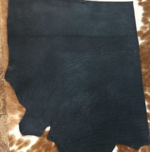 Premium quality black veg-tanned tooling and stamping leather is an excellent choice for your projects, as it undergoes a 100% vegetable tanning process through a drum process. All selections go through the same process, which guarantees quality in rupture, moisture, water penetration, and flexibility. This leather is ideal for use in crafting straps, belts, cinches, pet collars and leashes, footwear, holsters and sheaths, and strops. It is made from cowhide (double shoulder) and is 8-9 oz. thick (3.2 - 3.6 mm). The color is charcoal black (struck-through), and the average hide size is 14-17 sq. ft. The texture is smooth, and the temper is stiff. It is 100% veg-tanned and comes from Mexico.