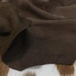 The Nubuck Lambskin Collection is a type of leather that feels soft and luxurious, with a trendy and eye-catching appearance. The leather undergoes a unique tanning process that involves lightly buffing the grain surface, resulting in a very soft and pleasing texture. This leather is suitable for various applications, including apparel, moccasins, toy and doll clothing, lining, handbags, shoes, and accessories. The leather comes in full hide specification, with an average size of 6-8 square feet. It is made from lamb skin and has a nubuck finish. The leather thickness is 2 oz (0.7-0.9mm)
