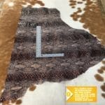 Python Embossed Cow leather, made from cowhide, is an excellent choice for DIY leather projects, such as arts and crafts, jewelry, leather earrings, bracelets, wallets, small leather goods, and patchwork. The key to success is having an inspirational idea. This leather is chrome-tanned and has a soft to medium temper. It comes in an average hide size of 3-5 sq. ft. and has a thickness of 3 oz (1.0-1.2 mm). Although it may have some holes or defects, it is free of PCP, Azo pigments, Chrome VI, Formaldehyde, and APEO, making it safe to use. To save on shipping costs, the leather is folded and inserted into a padded envelope. If you want to avoid creases due to folding, please contact us for special handling.
