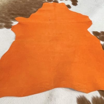 This Economy Goat Suede Leather is a soft and luxurious material that adds a chic touch to any style. It's perfect for creating accessories, handbags, shoes, belts, and apparel. The leather weighs 3oz and has a thickness of 1.0-1.2mm, with an average hide size of 2-3sq ft. The leather has a medium soft temper and was tanned using chrome. It may have some blemishes or holes, but it's still a high-quality manufacturing grade B leather. Originating from Italy, this suede leather is irresistible to the touch.