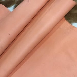 Lambskin Leather Grade C is a type of leather that might have some imperfections, but they do not affect its performance. Instead, these flaws give it a unique appearance. The leather's raw material is sourced from sheep or lamb, and it weighs 2 oz. with a thickness of 0.7-0.9 mm. Furthermore, the economy grade Lamb leather may have uneven shade tone, dark spots, stretch marks, scarring, scratches, or a few holes. However, these flaws do not affect its performance. Instead, they give it a unique appearance that sets it apart from other types of leather.