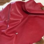 SL101-Red Lamb Skin Avetco Inc (11) | Avetco Leather Hides and Eva Foam Lambskin Leather Grade C is a type of leather that might have some imperfections, but they do not affect its performance. Instead, these flaws give it a unique appearance. The leather's raw material is sourced from sheep or lamb, and it weighs 2 oz. with a thickness of 0.7-0.9 mm. Furthermore, the economy grade Lamb leather may have uneven shade tone, dark spots, stretch marks, scarring, scratches, or a few holes. However, these flaws do not affect its performance. Instead, they give it a unique appearance that sets it apart from other types of leather.