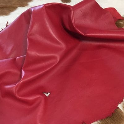 Lambskin Leather Grade C is a type of leather that might have some imperfections, but they do not affect its performance. Instead, these flaws give it a unique appearance. The leather's raw material is sourced from sheep or lamb, and it weighs 2 oz. with a thickness of 0.7-0.9 mm. Furthermore, the economy grade Lamb leather may have uneven shade tone, dark spots, stretch marks, scarring, scratches, or a few holes. However, these flaws do not affect its performance. Instead, they give it a unique appearance that sets it apart from other types of leather.