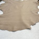 Lambskin Leather Grade C is a type of leather that might have some imperfections, but they do not affect its performance. Instead, these flaws give it a unique appearance. The leather's raw material is sourced from sheep or lamb, and it weighs 2 oz. with a thickness of 0.7-0.9 mm. Furthermore, the economy grade Lamb leather may have uneven shade tone, dark spots, stretch marks, scarring, scratches, or a few holes. However, these flaws do not affect its performance. Instead, they give it a unique appearance that sets it apart from other types of leather.