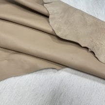 Lambskin Leather Grade C is a type of leather that might have some imperfections, but they do not affect its performance. Instead, these flaws give it a unique appearance. The leather's raw material is sourced from sheep or lamb, and it weighs 2 oz. with a thickness of 0.7-0.9 mm. Furthermore, the economy grade Lamb leather may have uneven shade tone, dark spots, stretch marks, scarring, scratches, or a few holes. However, these flaws do not affect its performance. Instead, they give it a unique appearance that sets it apart from other types of leather.