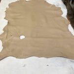 Lambskin Leather Grade C is a type of leather that might have some imperfections, but they do not affect its performance. Instead, these flaws give it a unique appearance. The leather's raw material is sourced from sheep or lamb, and it weighs 2 oz. with a thickness of 0.7-0.9 mm. Furthermore, the economy grade Lamb leather may have uneven shade tone, dark spots, stretch marks, scarring, scratches, or a few holes. However, these flaws do not affect its performance. Instead, they give it a unique appearance that sets it apart from other types of leather.