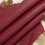 Lambskin Leather Grade C is a type of leather that might have some imperfections, but they do not affect its performance. Instead, these flaws give it a unique appearance. The leather's raw material is sourced from sheep or lamb, and it weighs 2 oz. with a thickness of 0.7-0.9 mm. Furthermore, the economy grade Lamb leather may have uneven shade tone, dark spots, stretch marks, scarring, scratches, or a few holes. However, these flaws do not affect its performance. Instead, they give it a unique appearance that sets it apart from other types of leather.