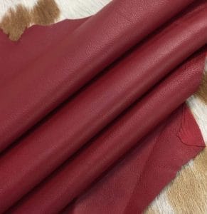 Lambskin Leather Grade C is a type of leather that might have some imperfections, but they do not affect its performance. Instead, these flaws give it a unique appearance. The leather's raw material is sourced from sheep or lamb, and it weighs 2 oz. with a thickness of 0.7-0.9 mm. Furthermore, the economy grade Lamb leather may have uneven shade tone, dark spots, stretch marks, scarring, scratches, or a few holes. However, these flaws do not affect its performance. Instead, they give it a unique appearance that sets it apart from other types of leather.